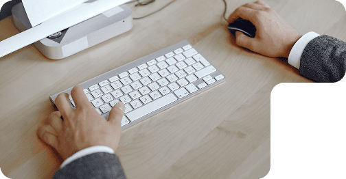 Hands typing on a white keyboard